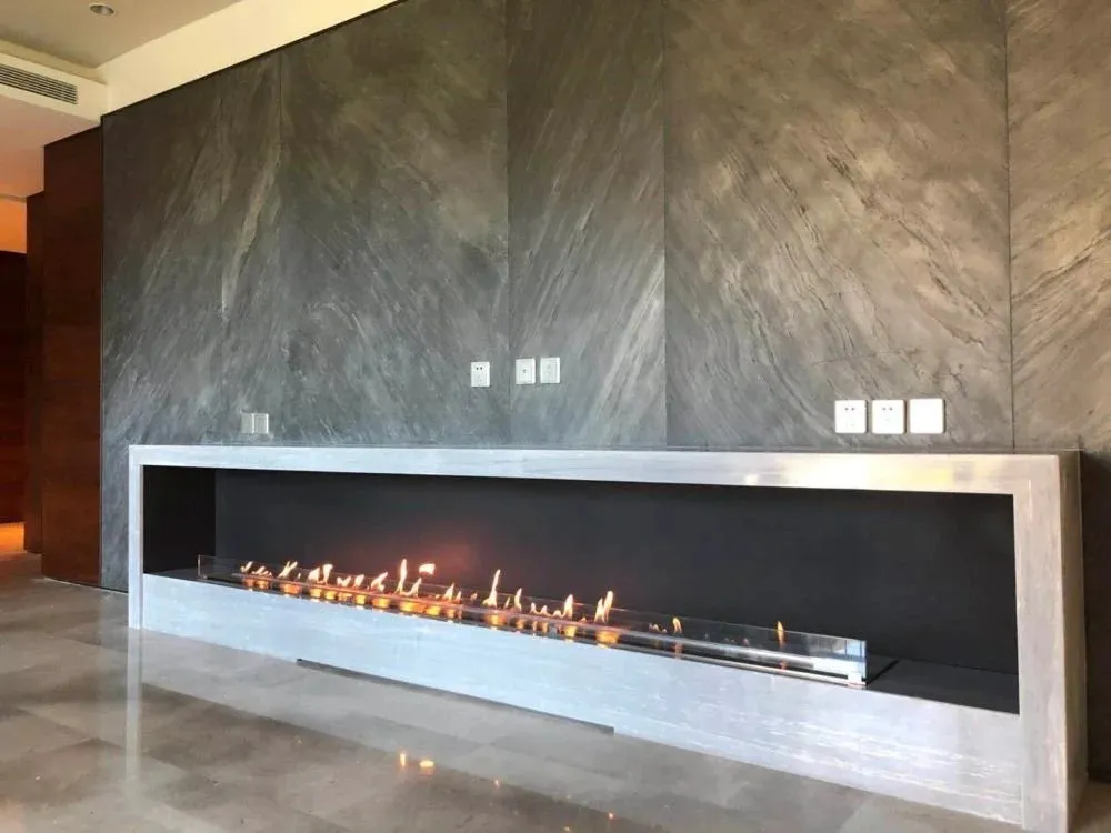 Long bioethanol fireplace in a stone wall