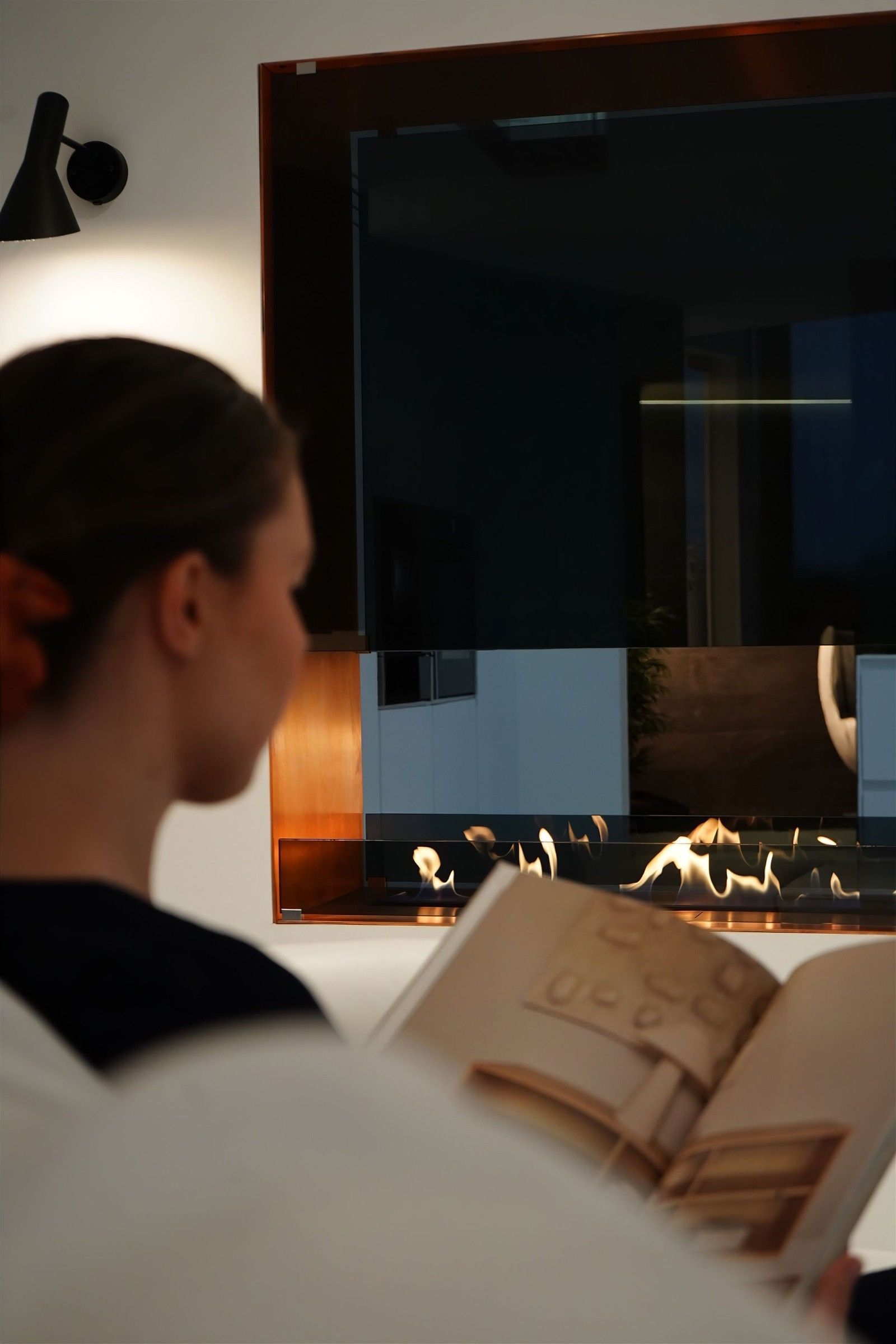 Reading beside a built-in bioethanol fireplace
